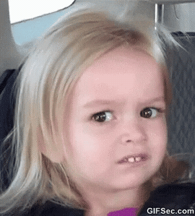 A Little Girl With Blonde Hair Is Making A Funny Face . GIF
