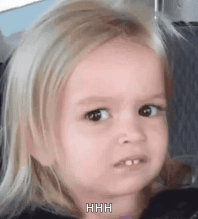A Little Girl With Blonde Hair Is Making A Funny Face While Sitting In A Car Seat . GIF