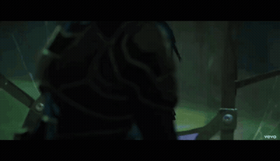A Little Girl With Blue Hair Is Standing In A Dark Room With A Vevo Logo On The Bottom GIF