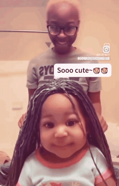 A Little Girl With Braids Has A Sticker That Says Sooo Cute On Her Head GIF