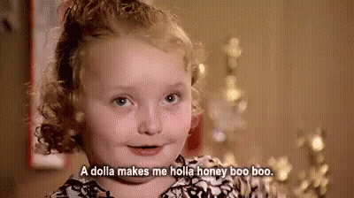 A Little Girl With Curly Hair Is Smiling And Saying `` A Dolla Makes Me Holla Honey Boo Boo '' . GIF
