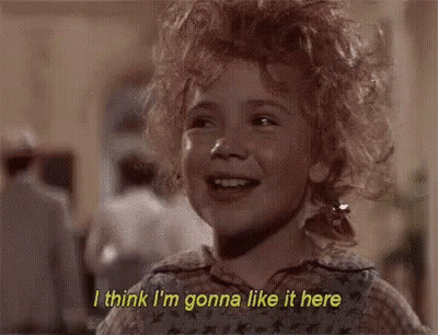 A Little Girl With Curly Hair Is Smiling And Saying I Think I 'M Gonna Like It Here . GIF