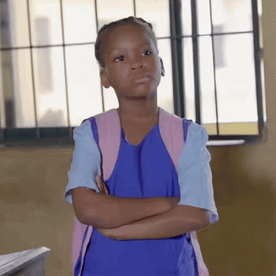 A Little Girl With Her Arms Crossed Wearing A Blue Dress And A Pink Backpack GIF