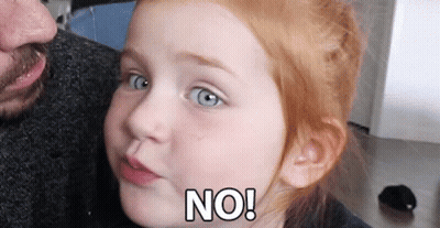 A Little Girl With Red Hair Is Making A Face And Says No GIF