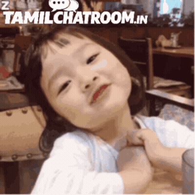 A Little Girl With Red Lips Is Being Held By Someone In A Tamil Chatroom GIF