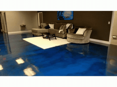 A Living Room With A Blue Floor And Couch GIF
