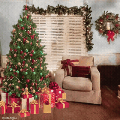 A Living Room With A Christmas Tree And Presents Underneath It GIF