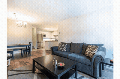 A Living Room With A Couch And A Table GIF