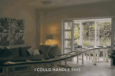 A Living Room With A Couch And A Table And The Words " I Could Handle This " GIF