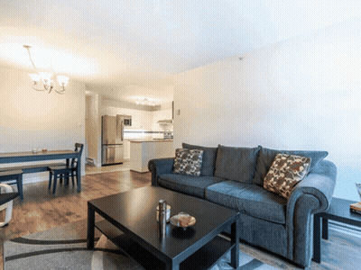 A Living Room With A Couch And A Table GIF