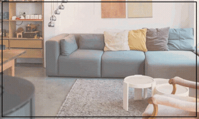 A Living Room With A Couch And Two Tables And A Shelf With Toys On It GIF