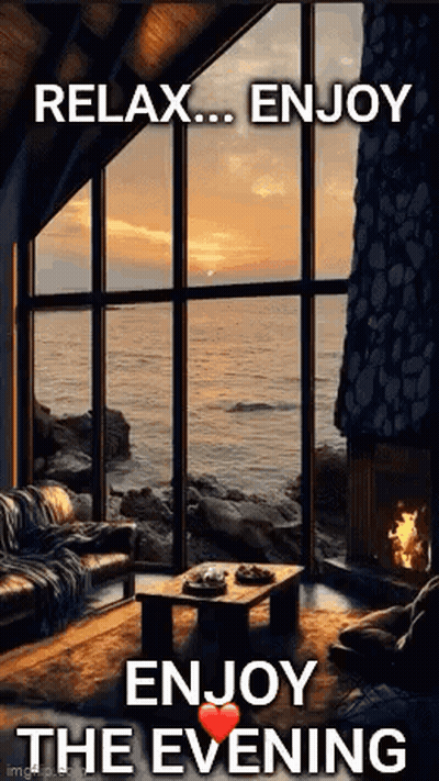 A Living Room With A Fireplace And A Large Window Overlooking The Ocean With The Words `` Relax ... Enjoy The Evening '' GIF