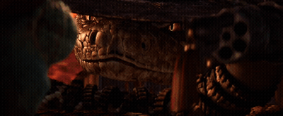 A Lizard Wearing A Cowboy Hat Looks At The Camera GIF