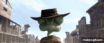 A Lizard Wearing A Cowboy Hat Stands In Front Of A Motel Sign GIF