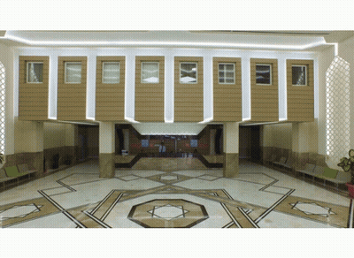 A Lobby With A Geometric Pattern On The Floor And A Counter GIF