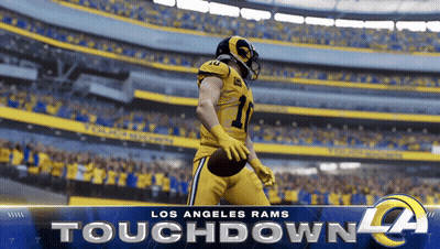 A Los Angeles Rams Football Player Is Holding A Football GIF