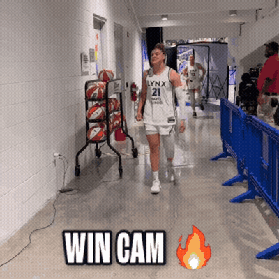 A Lynx Basketball Player Walks Down The Hallway GIF