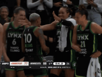 A Lynx Player Is Hugging Another Player During A Basketball Game GIF