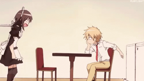 A Maid Is Standing Next To A Man Sitting At A Table In A Restaurant . GIF