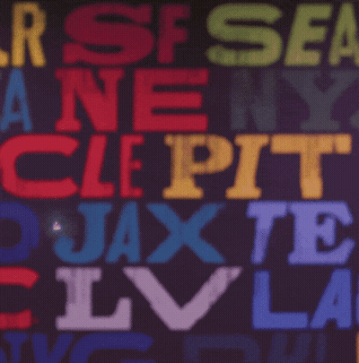 A Man Adjusts His Green Bay Packers Hat In Front Of A Colorful Background GIF