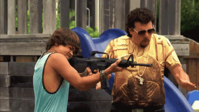 A Man And A Boy Are Playing With A Gun At A Playground GIF