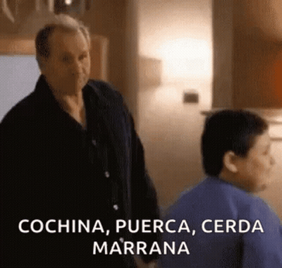 A Man And A Boy Are Standing Next To Each Other In A Kitchen And The Man Is Talking To The Boy . GIF