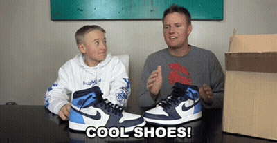 A Man And A Boy Sit At A Table With A Pair Of Cool Shoes GIF