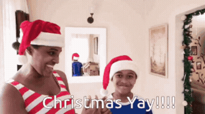 A Man And A Boy Wearing Santa Hats With The Words Christmas Yay !!! GIF