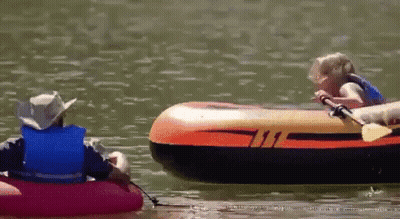 A Man And A Child Are In A Raft On A Lake GIF