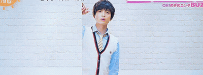 A Man And A Girl Are Standing In Front Of A Brick Wall With The Number 7 On The Bottom GIF