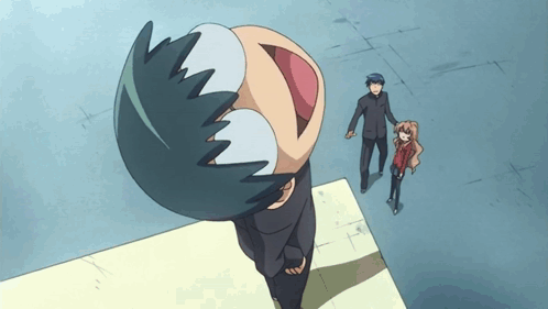 A Man And A Girl Are Standing Next To A Cartoon Character With A Big Mouth GIF