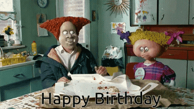 A Man And A Girl Sitting At A Table With The Words Happy Birthday Written On The Table GIF