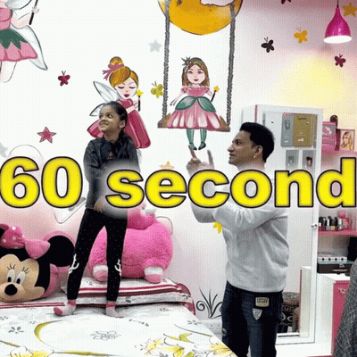 A Man And A Girl Standing In Front Of A Wall That Says 60 Second GIF