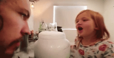 A Man And A Little Girl Are Playing With A Jar . GIF