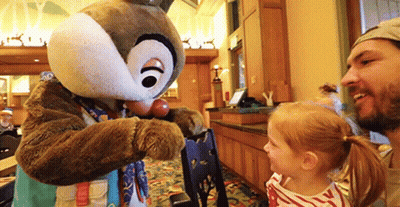 A Man And A Little Girl Are Standing Next To A Chipmunk Mascot . GIF