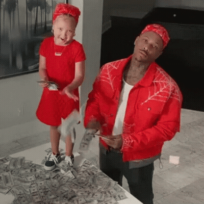A Man And A Little Girl Are Standing Next To Each Other On A Pile Of Money . GIF