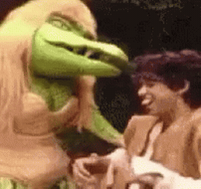 A Man And A Monster Are Standing Next To Each Other . GIF