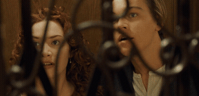 A Man And A Woman Are Behind A Fence And The Woman Is Giving The Middle Finger GIF