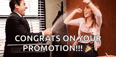 A Man And A Woman Are Celebrating A Promotion In An Office . GIF