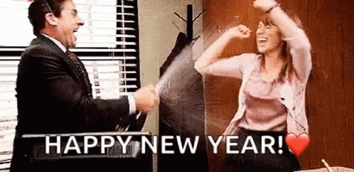 A Man And A Woman Are Celebrating New Year 'S Eve In The Office . GIF