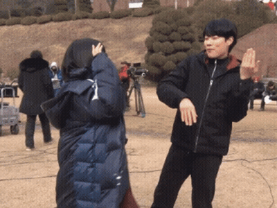 A Man And A Woman Are Dancing In A Park GIF