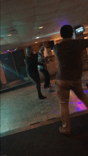 Man And Woman Dancing In Purple Lighted Room GIF