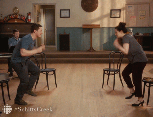 A Man And A Woman Are Dancing In A Room With The Hashtag Schitts Creek GIF