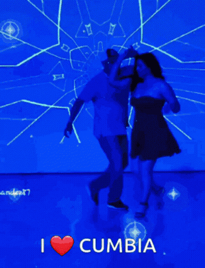 A Man And A Woman Are Dancing In Front Of A Blue Screen That Says I Love Cumbia GIF