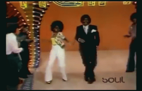 A Man And A Woman Are Dancing In Front Of A Sign That Says Soul On It GIF