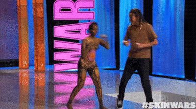 A Man And A Woman Are Dancing In Front Of The Word Skin Wars GIF