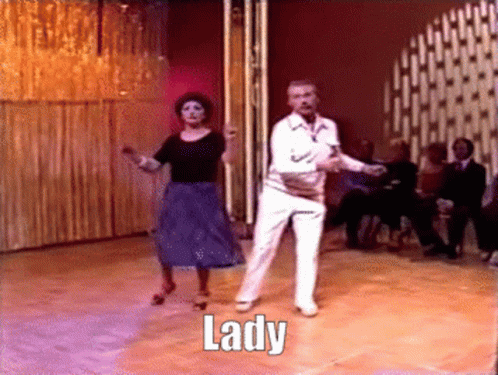 A Man And A Woman Are Dancing On A Dance Floor And The Word Lady Is On The Floor GIF