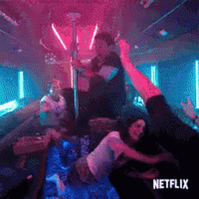 A Man And A Woman Are Dancing On A Pole In A Nightclub . GIF
