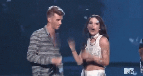 A Man And A Woman Are Dancing On A Stage At A Mtv Event . GIF