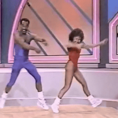 A Man And A Woman Are Dancing On A Stage On A Show . GIF